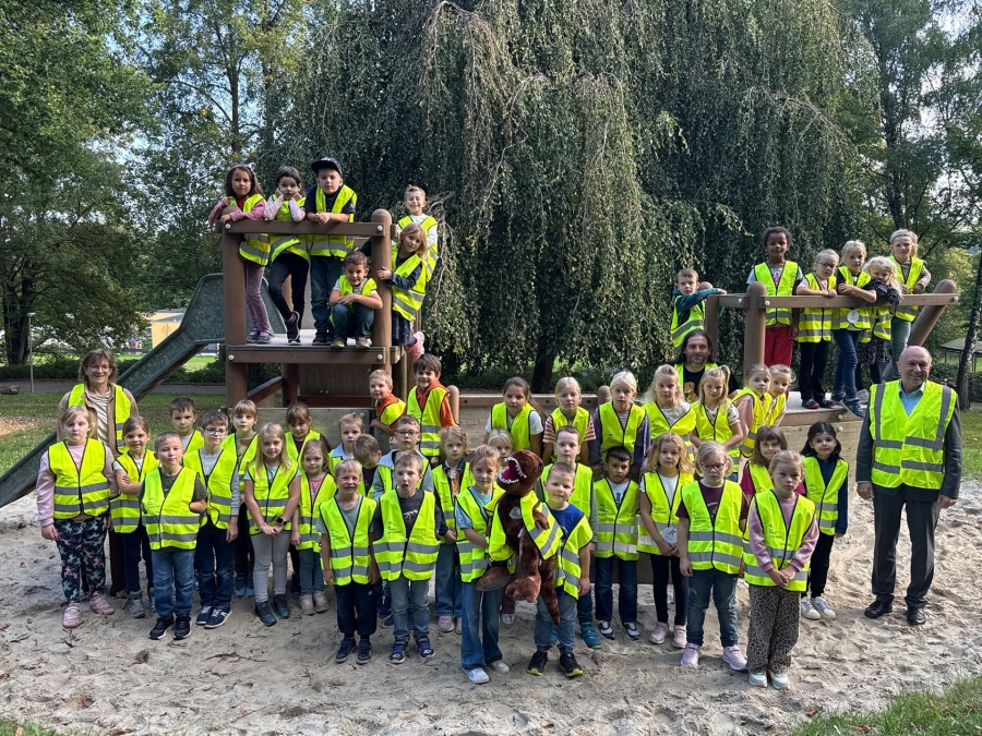 Bereit für ihren Schulweg: Die Erstklässlerinnen und Erstklässler der Grundschule Altenautal erhalten von Landrat Christoph Rüther (r.) reflektierende Warnwesten. Lichtenaus Bürgermeisterin Ute Dülfer (l.) und Schulleiter Markus Kremer (mittig) unterstützen die Aktion. ©Kreis Paderborn, Diana Ramme